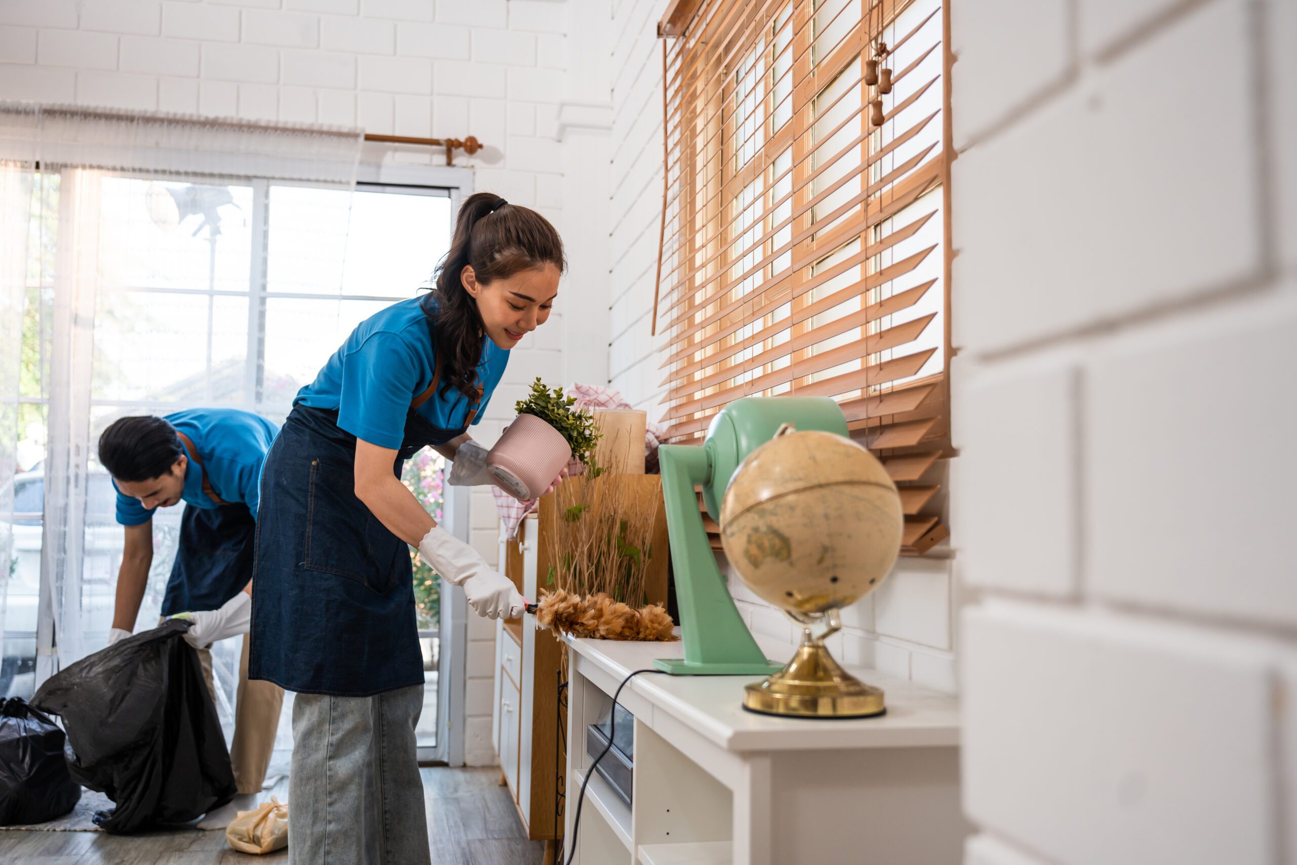 Asian young man and woman providing cleaning service